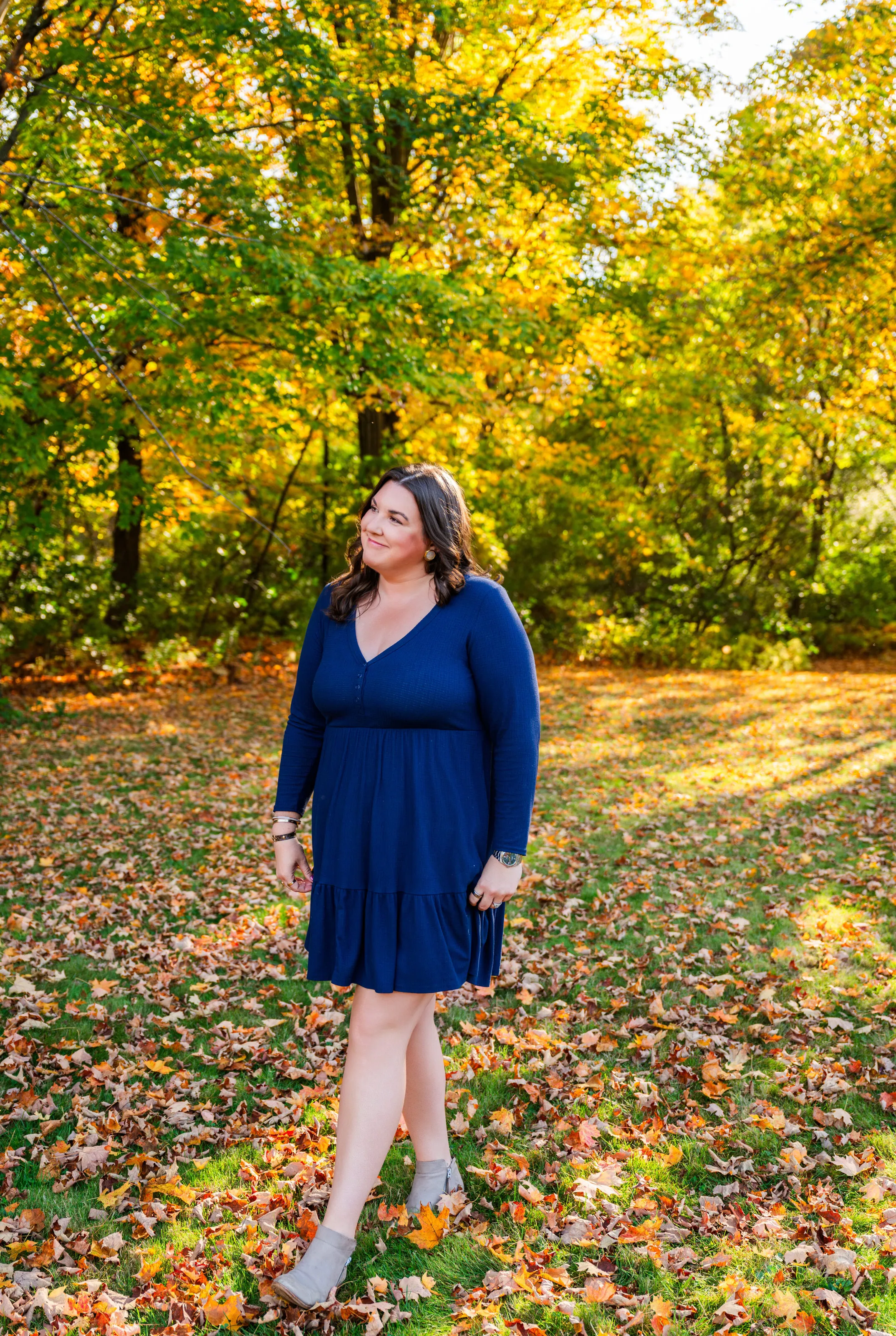 Erin McCormick standing in autumn leaves